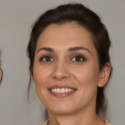 Joyful white young-adult female with medium  brown hair and brown eyes