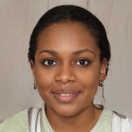 Joyful black young-adult female with medium  black hair and brown eyes