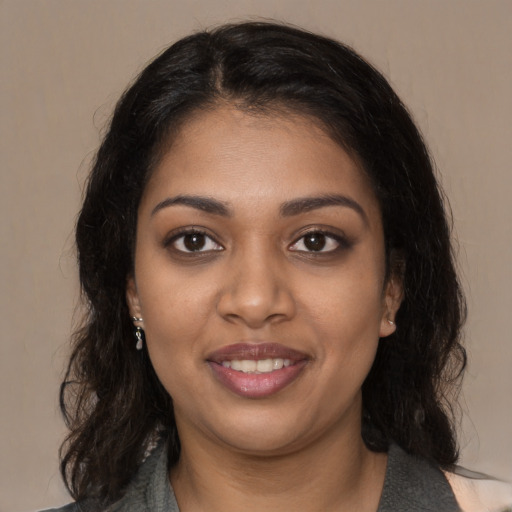 Joyful black young-adult female with medium  brown hair and brown eyes