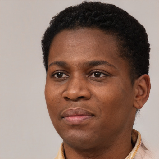 Joyful black young-adult female with short  black hair and brown eyes