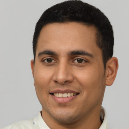 Joyful latino young-adult male with short  brown hair and brown eyes