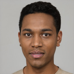 Joyful black young-adult male with short  black hair and brown eyes