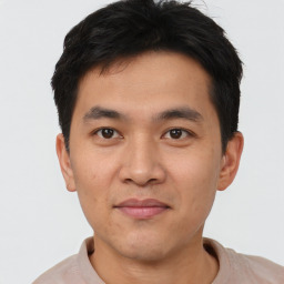 Joyful asian young-adult male with short  brown hair and brown eyes