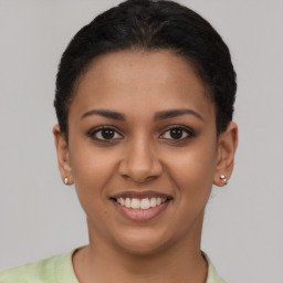 Joyful latino young-adult female with short  brown hair and brown eyes