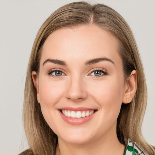 Joyful white young-adult female with long  brown hair and blue eyes