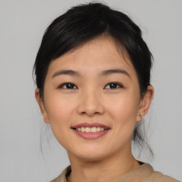 Joyful asian young-adult female with medium  brown hair and brown eyes