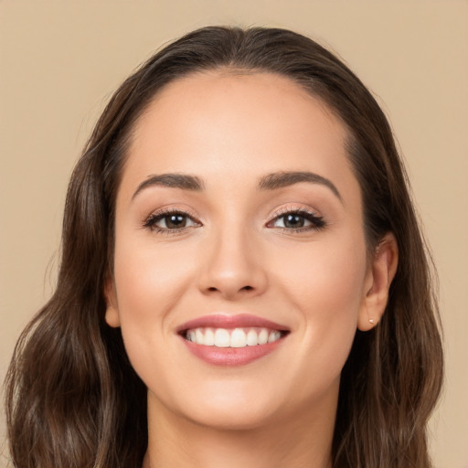 Joyful white young-adult female with long  brown hair and brown eyes