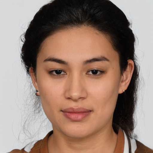 Joyful latino young-adult female with medium  brown hair and brown eyes