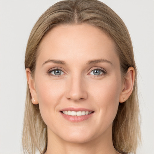 Joyful white young-adult female with long  brown hair and blue eyes