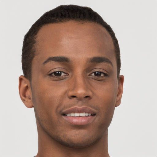 Joyful black young-adult male with short  brown hair and brown eyes