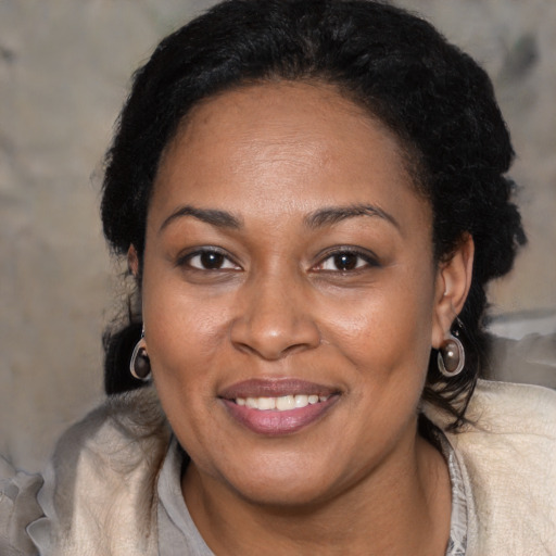Joyful latino adult female with short  brown hair and brown eyes