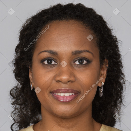 Joyful black young-adult female with long  brown hair and brown eyes