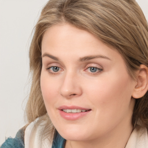 Joyful white young-adult female with medium  brown hair and blue eyes