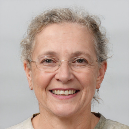 Joyful white middle-aged female with medium  brown hair and blue eyes