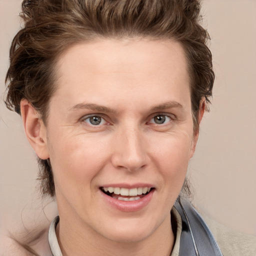 Joyful white adult female with short  brown hair and grey eyes