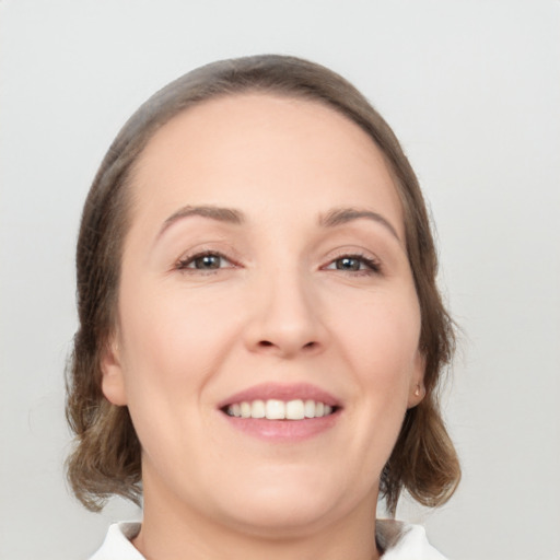 Joyful white young-adult female with medium  brown hair and brown eyes