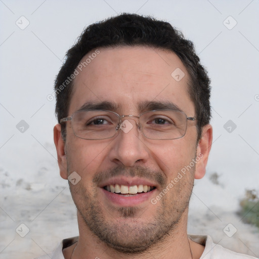 Joyful white adult male with short  black hair and brown eyes