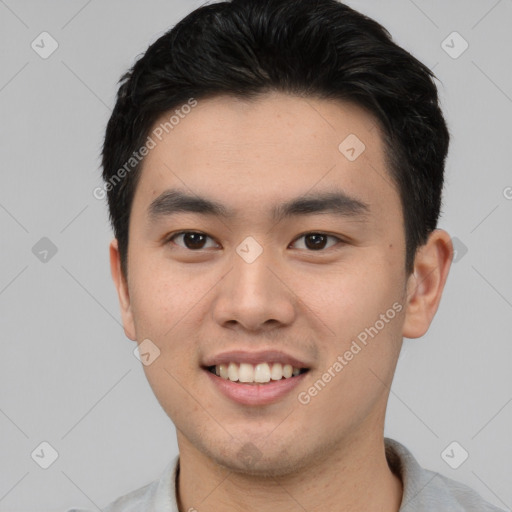 Joyful asian young-adult male with short  black hair and brown eyes