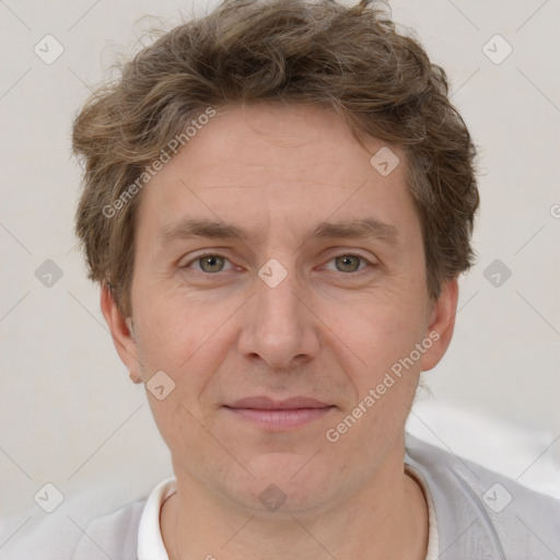 Joyful white adult male with short  brown hair and grey eyes