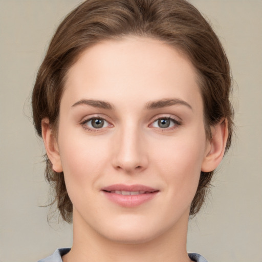 Joyful white young-adult female with medium  brown hair and green eyes