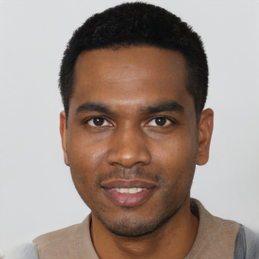 Joyful black young-adult male with short  black hair and brown eyes