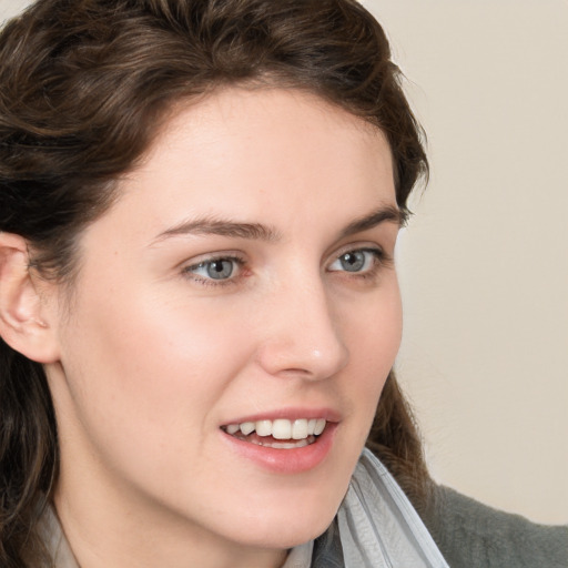 Joyful white young-adult female with medium  brown hair and blue eyes