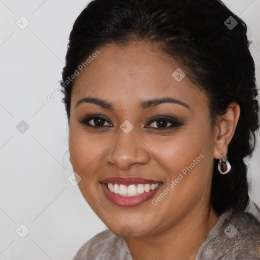 Joyful black young-adult female with long  brown hair and brown eyes