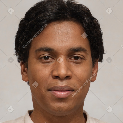 Joyful black young-adult male with short  brown hair and brown eyes