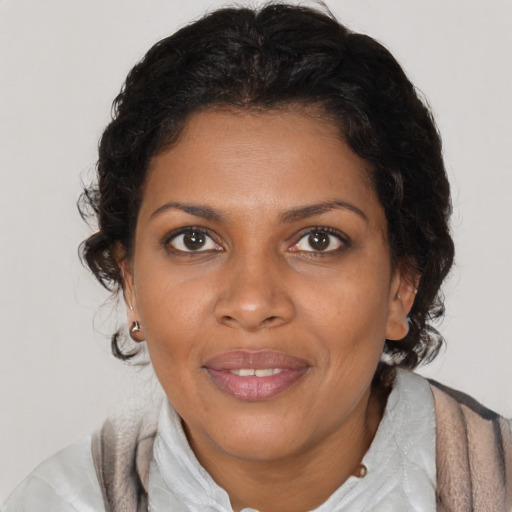 Joyful black young-adult female with medium  brown hair and brown eyes