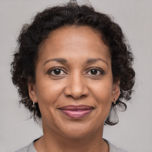 Joyful latino adult female with medium  brown hair and brown eyes
