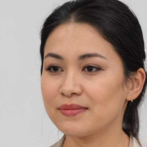 Joyful asian young-adult female with medium  brown hair and brown eyes