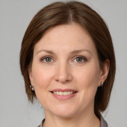 Joyful white adult female with medium  brown hair and grey eyes