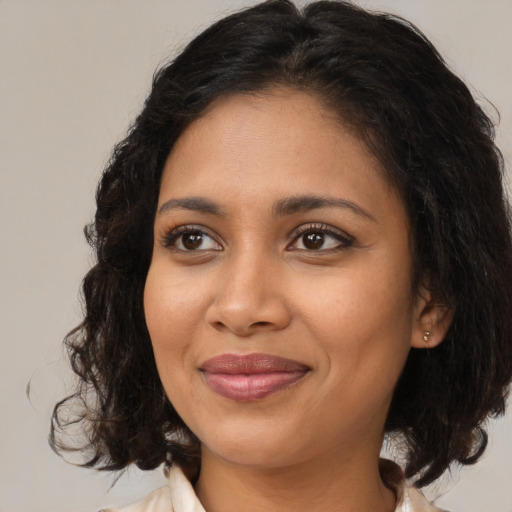 Joyful black young-adult female with medium  brown hair and brown eyes