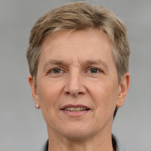 Joyful white middle-aged male with short  brown hair and grey eyes