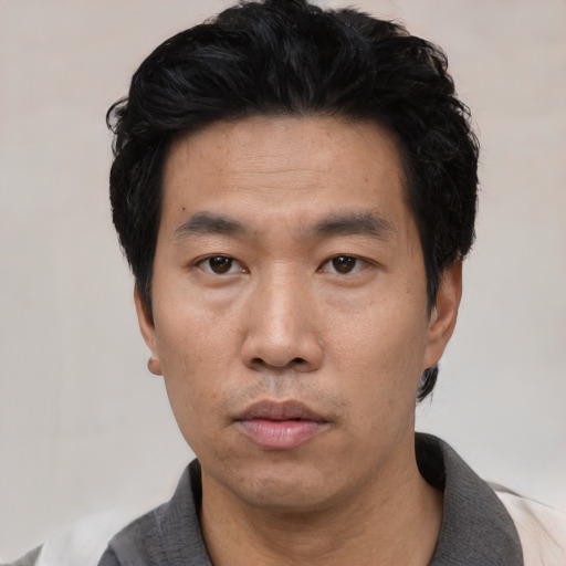 Neutral asian adult male with short  black hair and brown eyes