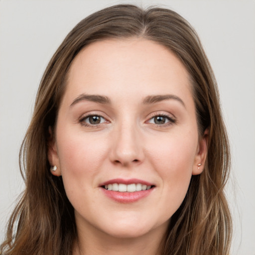 Joyful white young-adult female with long  brown hair and grey eyes