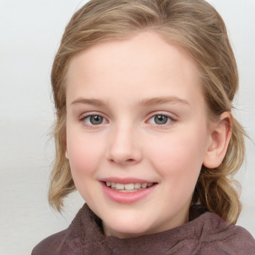 Joyful white child female with medium  brown hair and blue eyes