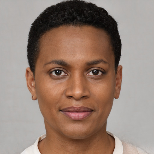 Joyful black young-adult female with short  black hair and brown eyes