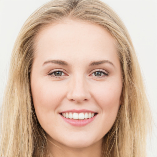 Joyful white young-adult female with long  brown hair and blue eyes