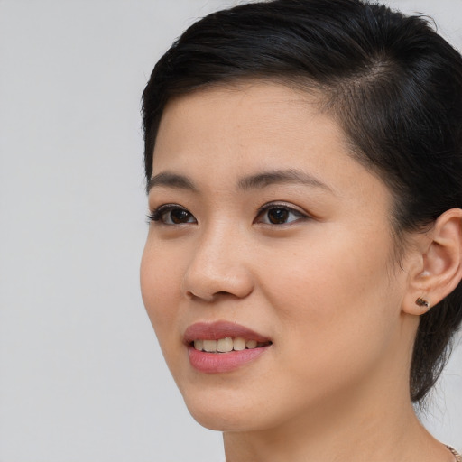 Joyful asian young-adult female with medium  brown hair and brown eyes