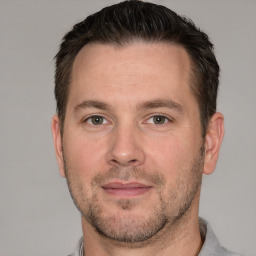 Joyful white adult male with short  brown hair and brown eyes