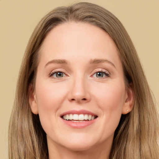 Joyful white young-adult female with long  brown hair and grey eyes