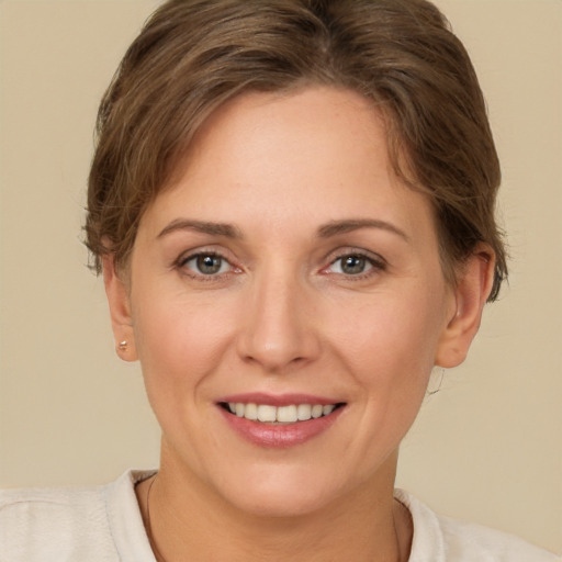 Joyful white adult female with short  brown hair and brown eyes