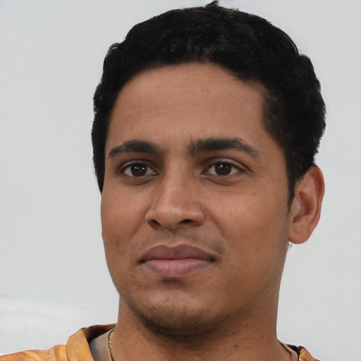 Joyful latino young-adult male with short  black hair and brown eyes