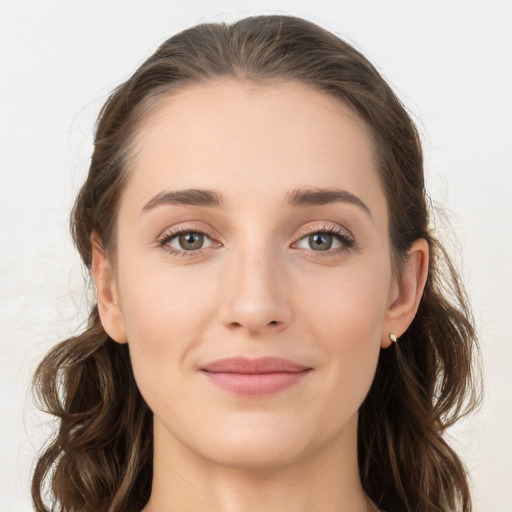 Joyful white young-adult female with long  brown hair and grey eyes