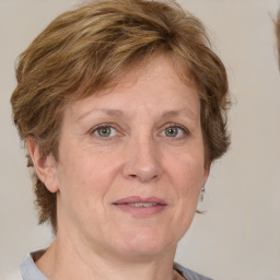 Joyful white adult female with medium  brown hair and grey eyes