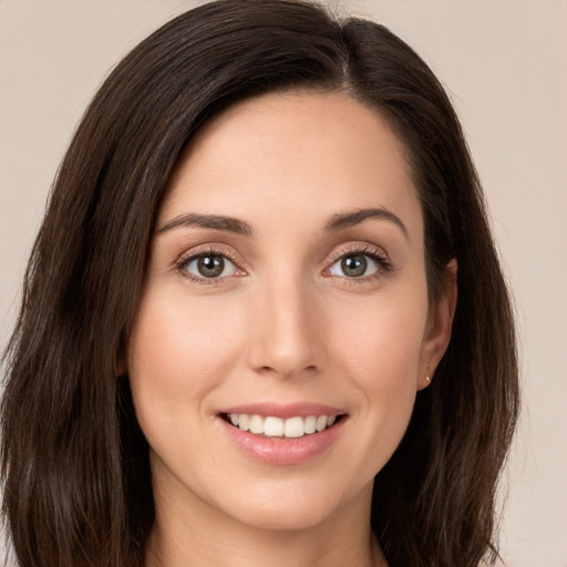 Joyful white young-adult female with long  brown hair and brown eyes