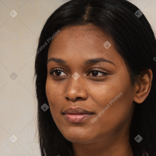 Joyful black young-adult female with long  black hair and brown eyes