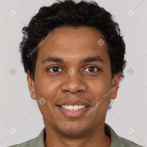 Joyful black young-adult male with short  brown hair and brown eyes