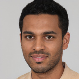 Joyful latino young-adult male with short  black hair and brown eyes